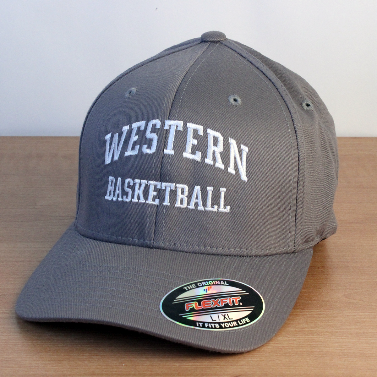 Grey ball cap with Western Basketball embroidered onto the front in white lettering.