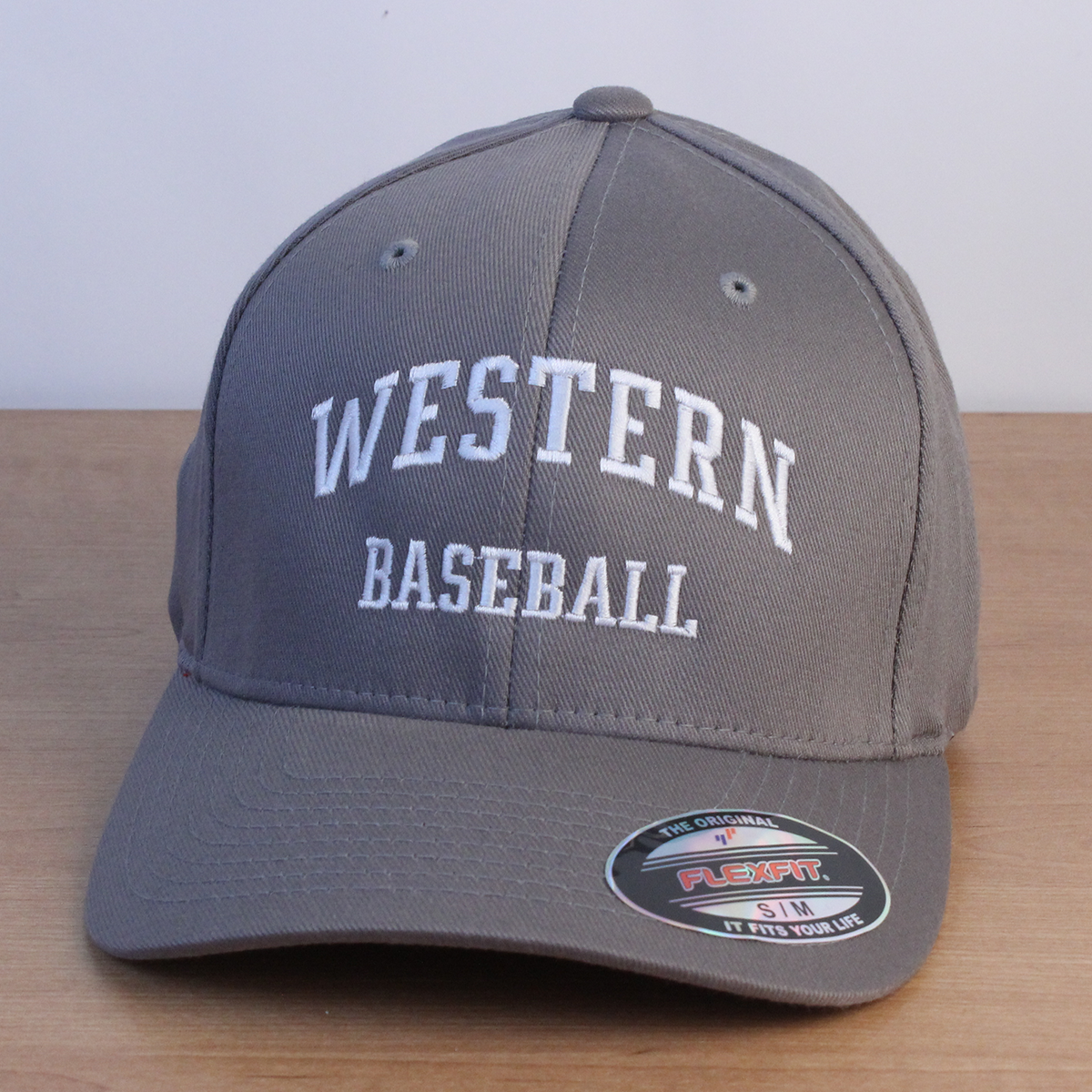 Grey ball cap with Western Baseball embroidered on the front in white lettering.