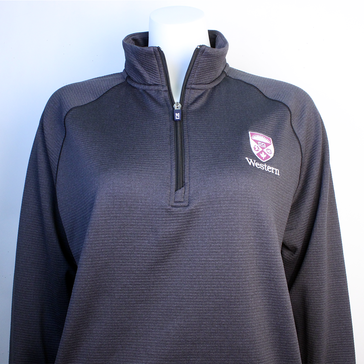 Black heather textured quarter zip long sleeve with the Western Crest and script on the left chest.