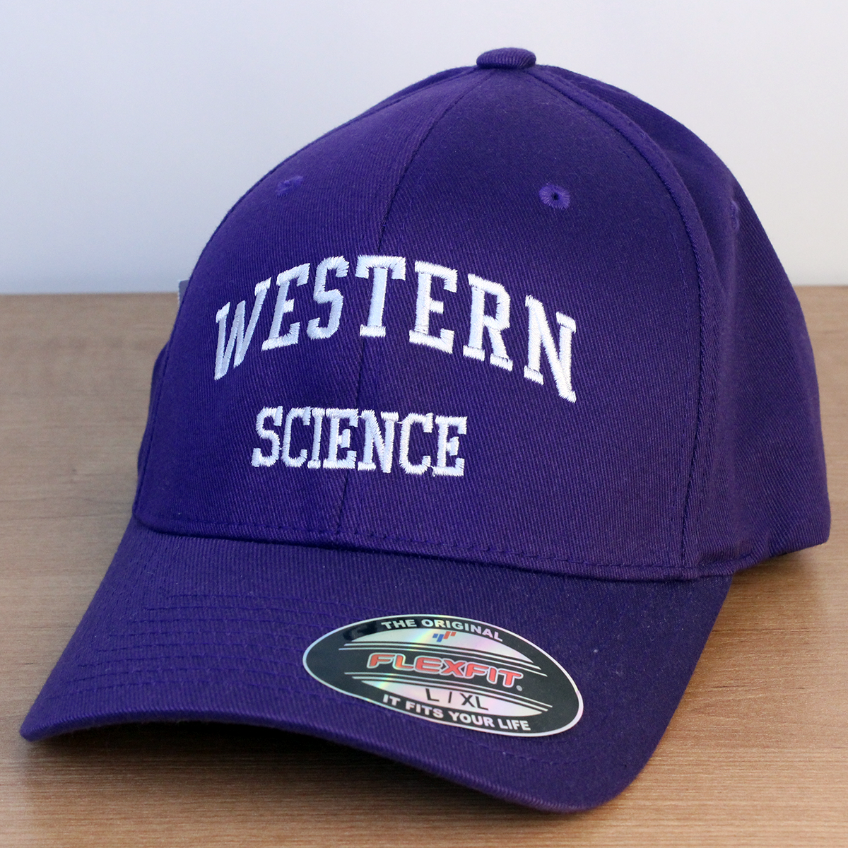 Purple ball cap with Western Science embroidered in white on the front. L/XL sizing.