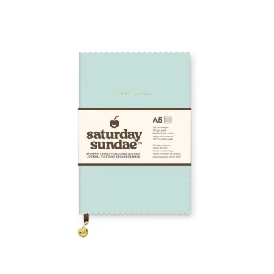 Large bound teal notebook with scalloped edge