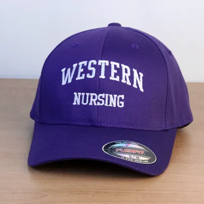Purple ball cap with Western Nursing embroidered onto the front in white lettering. S/M sizing.