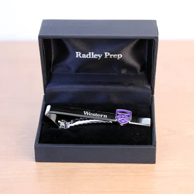 Silver tie bar with a western crest embellishment. 