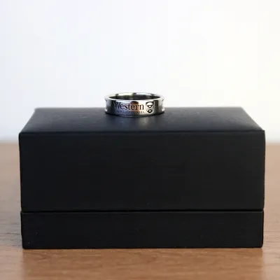 Silver pledge ring displayed on a black ring box.
