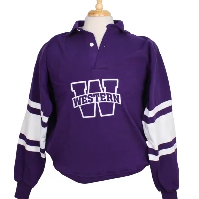 Rugby long sleeve shirt with purple an white stripes along the sleeves. Buttoned collar and cuffed sleeves. "Western W" graphic on the front of the shirt. 