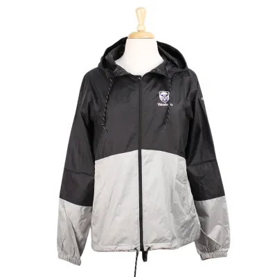 Black and grey Columbia hooded windbreaker with elastic cuffs and zippered front pockets. 'Western' and stacked crest embroidered on the left chest in purple and white.