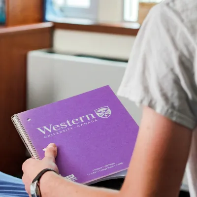 Boy holding a western notebook