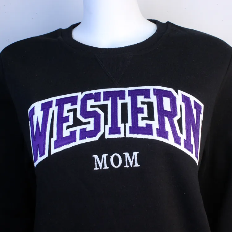 Black crewneck with large Western script across the chest and the word "Mom" centered underneath.
