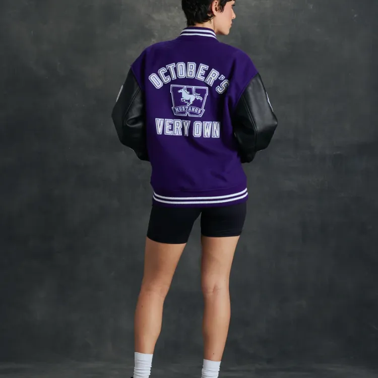 Purple Varsity jacket with leather black sleeves and embroidered patches back side view.