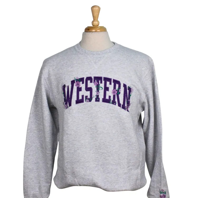 Ash grey crewneck with Western and floral embellishments embroidered on the front and on the sleeve.