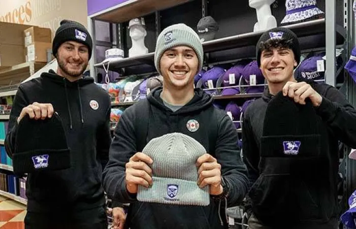 Toques from the Heart founders holding up custom-made Western Toques