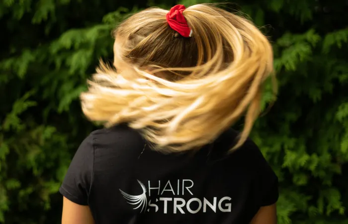 Woman turning head showing ponytail movement and red hair tie
