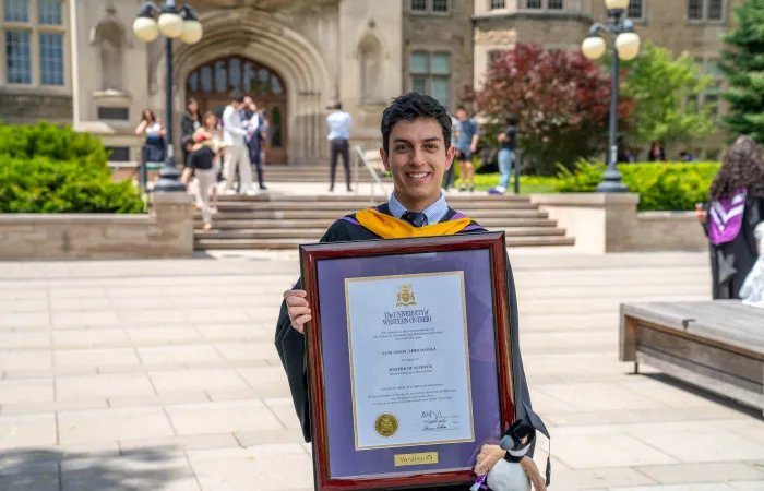 Graduate Holding Framed Diploma