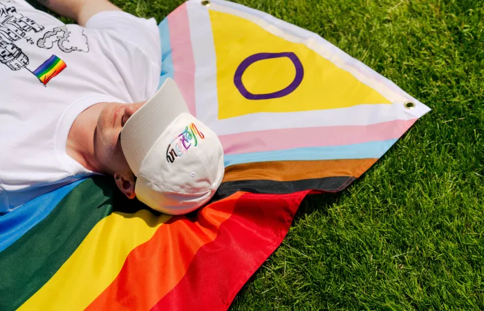 Man laying down on a pride flag