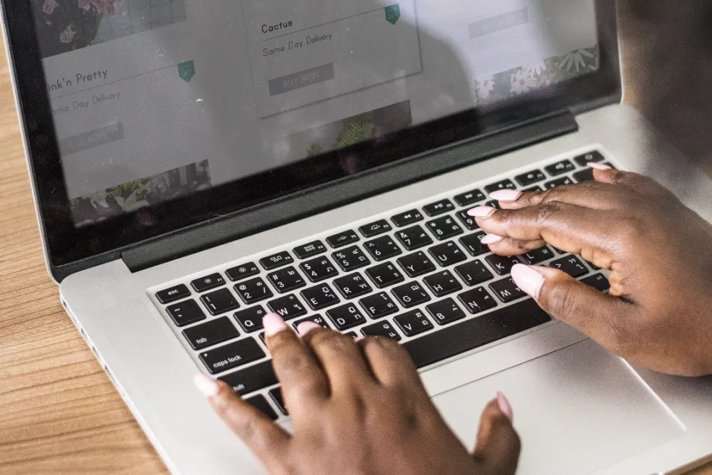 a person typing on their laptop